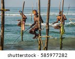 Small photo of WELIGAMA, SRI LANKA - JANUARY 11 2017: Unidentified local fishermen are fishing in unique style. This type of fishing is traditional for Sri Lanka in Indian ocean.