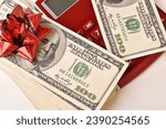 Paper money dollar banknotes, bow and calculator
