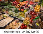 Small photo of Barcelona, Spain – April 17, 2018: Horizontal view of the merchandise of a greengrocer in the old Abaceria Central Market of the Gracia neighborhood