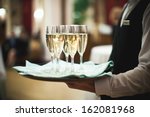 Waiter serving champagne on a tray