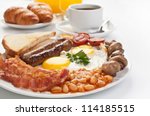 Traditional Full English Breakfast - sunny-side-up fried eggs, sausages, beans, mushrooms and bacon