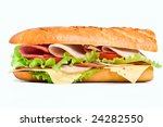 half of long baguette sandwich with lettuce, tomatoes, ham, turkey breast and cheese
