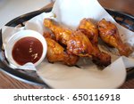 Small photo of Fried chicken. A Buffalo wing is an unbranded chicken wing section (flat or drumbeat) that is generally deep fried then coated in a sauce consisting of a vinegar based cayenne pepper hot sauce.