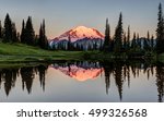 The Glowing Peak of Mount Rainier at Dawn with a calm reflection from the shore of Tipsoo Lake. Mount Rainier National Park, Washington State, USA