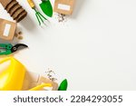 Small photo of Gardening tools, peat pots, seeds packets, watering can on white background. Spring garden works concept.