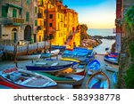 Riomaggiore village street, boats and sea in Five lands on sunset, Cinque Terre National Park, Liguria Italy Europe.