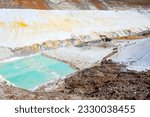 Small photo of Quarry extraction porcelain clay(kaolin) and quartz sand in the open pit mine. Powerful industrial caterpillar excavator on the site.