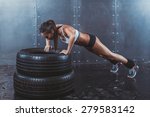 Sportswoman. Fit sporty woman doing push ups on tire strength power training concept crossfit fitness workout sport and lifestyle 