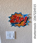 Small photo of Los Angeles, CA - September 12, 2023: Explosive ZAP sign on wall next to light switch. Conceptual.