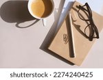 aesthetic minimalist workspace. Home office, blog, social media concept. Note book, coffee and glasses in soft pastele colors