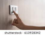 Close up of male finger is turn on or off on light switch with wood wall at home. Power, Energy, Saving Electrical. Copy space. 
