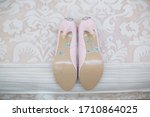 wedding day. wedding background. wedding details and accessory. pink bridal high heels shoes decorated with shiny rhinestones and stones close up. women's shoes decorated the inscription 