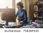 Teenager playing at computer game. Boy at home