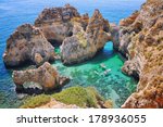 Ponta da Piedade - two boats with tourists between famous rocks in the ocean. Number one attraction in Lagos, Algrave, Portugal