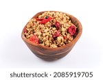 Muesli cereals in bowl with  raisins, oat and wheat flakes, fruits, strawberry, cranberry, cherry pieces. Isolated on white
