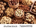 A variety of nuts in wooden bowls.