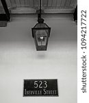 Small photo of New Orleans, LA USA - May 9, 2018 - Gas Lamp at 523 Iberville Street in the French Quarter in B&W