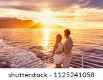 Travel cruise ship couple on sunset cruise in Hawaii holiday. Two tourists lovers on honeymoon travel enjoying summer vacation.