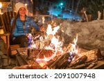 Winter campfire couple roasting ...