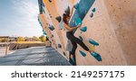 Small photo of Bouldering climbing athlete woman training strength at outdoor gym boulder climb wall. Asian fit girl going up having fun in extreme sport hobby. Banner panoramic
