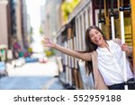 Happy Asian young woman excited having fun riding the popular tourist attraction tramway cable car system in San Francisco city, California during summer vacation. Tourism lifestyle.