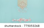 Small photo of Multicolor sweets sugar candy hearts pour forth of craft paper envelope on the light blue background . Valentine day. love concept. Gift, message for lover. Space for text. Wide banner