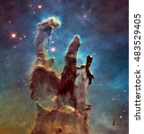 The Eagle Nebulaas Pillars of Creation. This image shows the pillars as seen in visible light, capturing the multi-coloured glow of gas clouds, Elements of this image are furnished by NASA. 