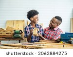 Happy family african american father and son carpenter gather craft a car out of wood and play, family concept to stay at home and enjoy good relationship hobby together craftsman or carpenter