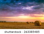 Sunset Over Farm Field With Hay ...